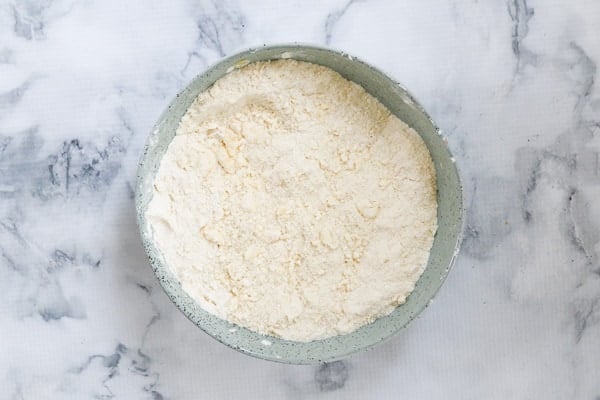 Self-raising flour and butter in a bowl mixed to make crumbs.
