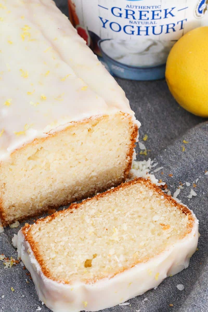 A lemon loaf being cut into slices. 