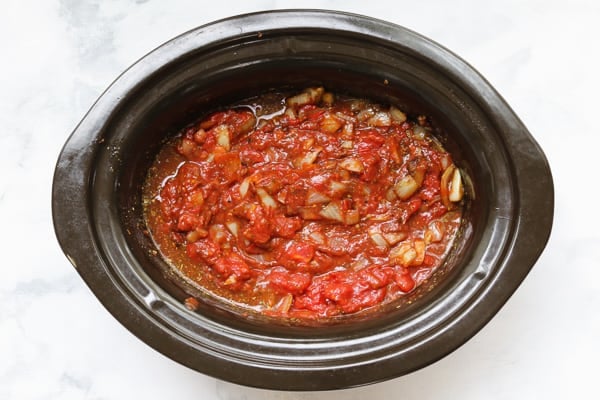 Tomato and onion in a slow cooker.