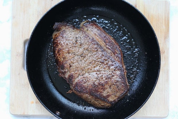 Seared roast beef in a frying pan.