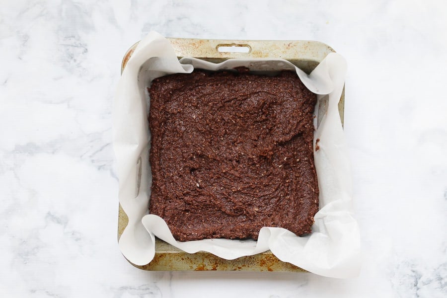 Chocolate mixture in a square slice pan.