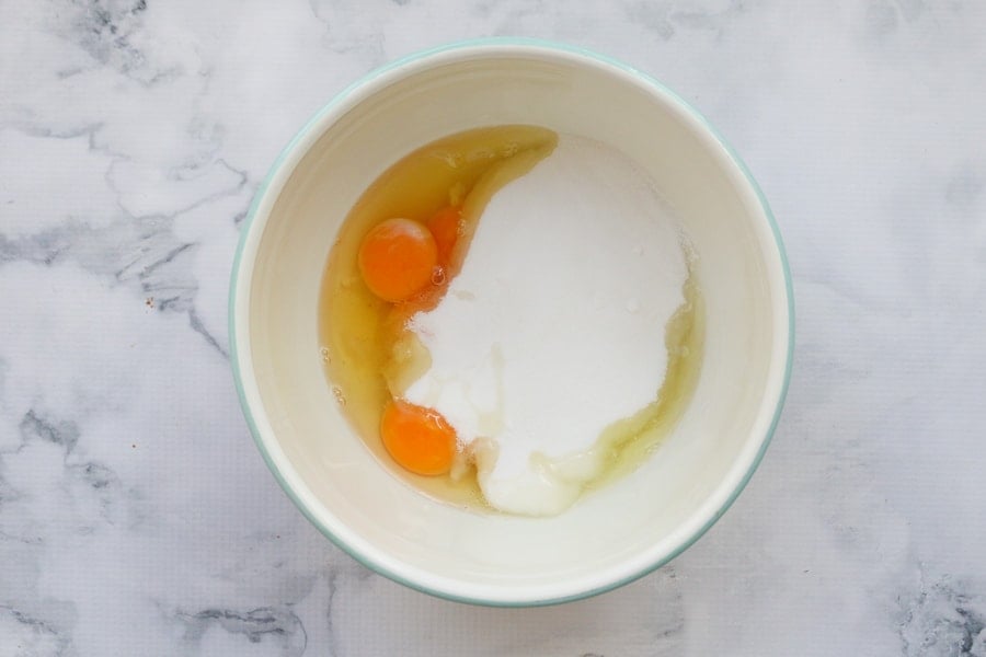 Eggs and sugar in a mixing bowl. 