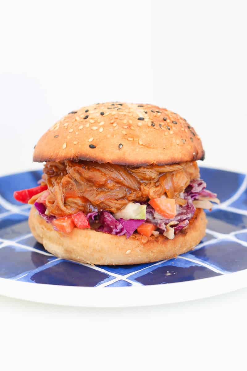 A brioche burger with coleslaw and pulled pork. 