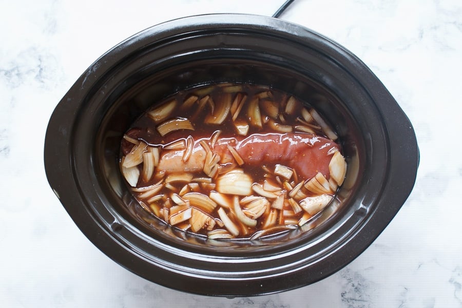 BBQ sauce, chopped onions and pork tenderloin in a slow cooker. 