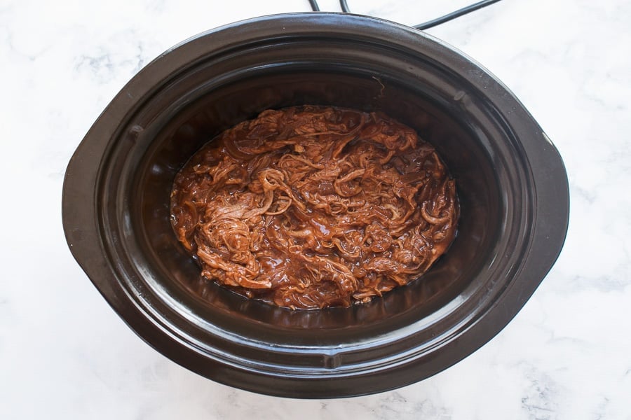 Shredded pork in a BBQ sauce in a crockpot.