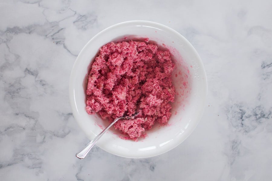 A pink mixture of coconut, sweetened condensed milk and chopped glace cherries.