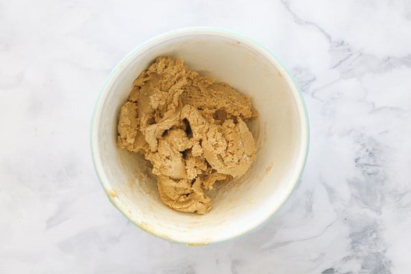 Gingerbread cookie dough in a bowl ready to be chilled in the fridge. 