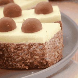Pieces of white chocolate topped Malteser slice.
