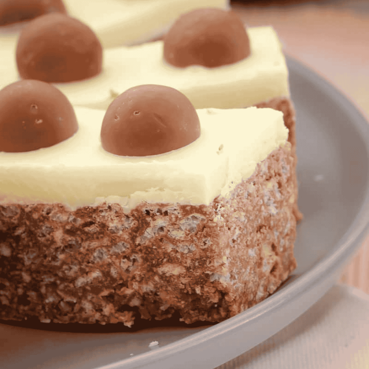 Pieces of white chocolate topped Malteser slice.