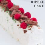 A whipped cream chocolate ripple cake decorated with peppermint crisp, raspberries and chocolate.
