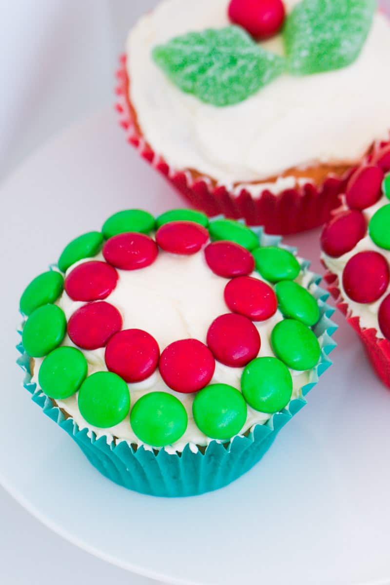 Vanilla cupcakes with buttercream and red and green M&Ms to decorate.