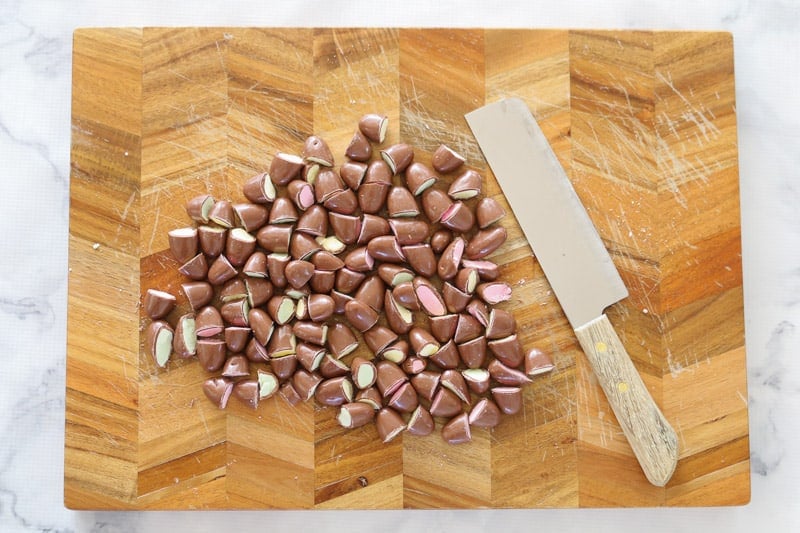 A chopping board with Clinkers lollies being chopped in half.
