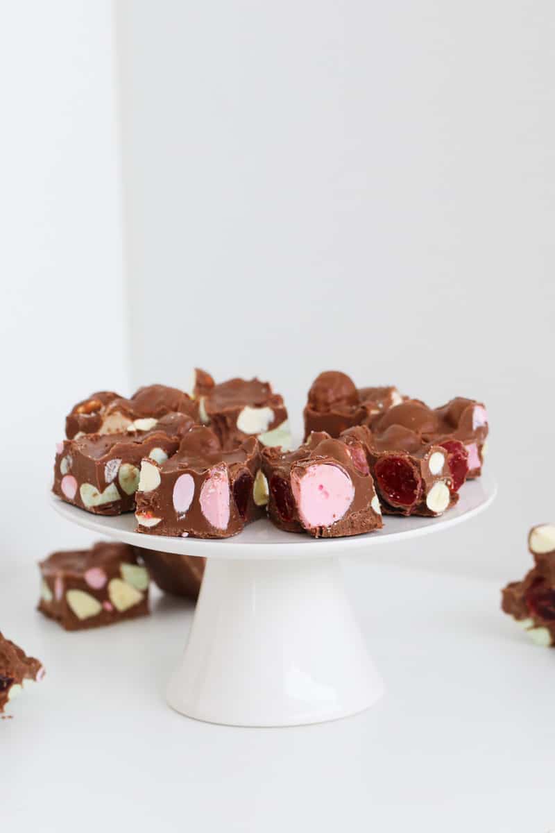 A plate rocky road with marshmallows and lollies.