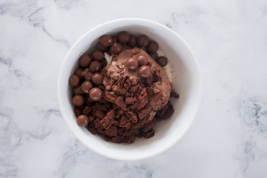 Chocolate ice-cream in a mixing bowl with Maltesers. 