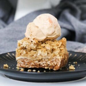 Homemade Apple Crumble Slice filled with sweet apple slices and topped with an oat streusel crumble. Serve it cold or warm it up for a decadent dessert!