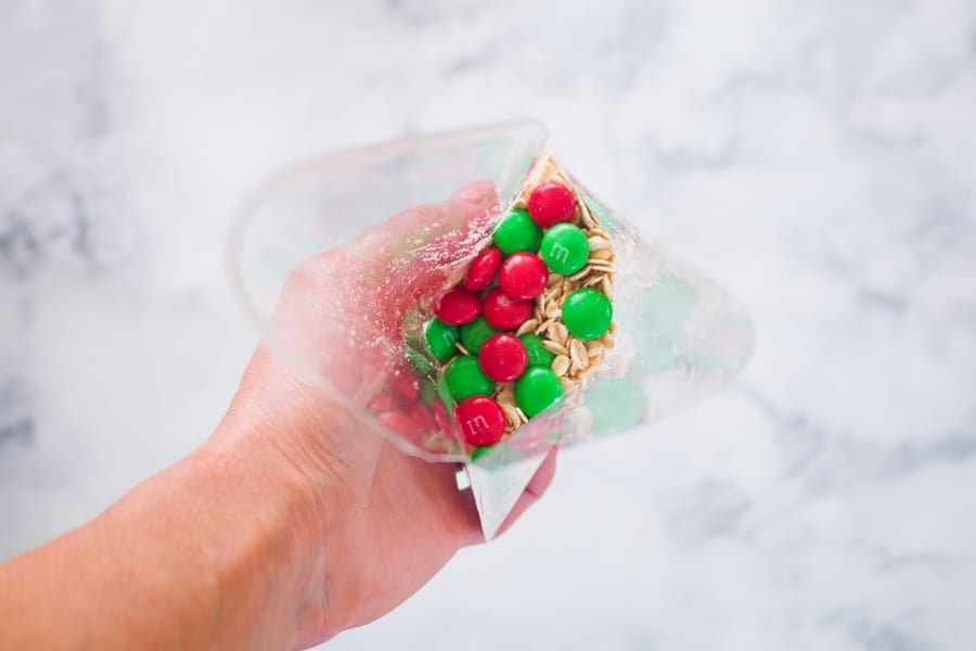Red and green Christmas M&Ms in a clear plastic bag.