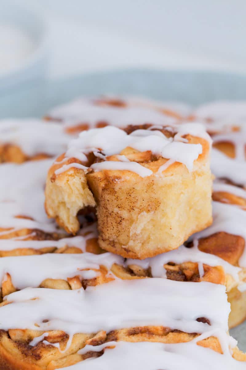 A roll with cinnamon and apple and white sugar glaze.