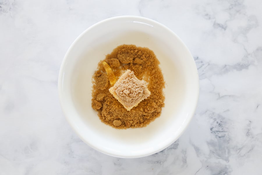 Butter and brown sugar in a white bowl.