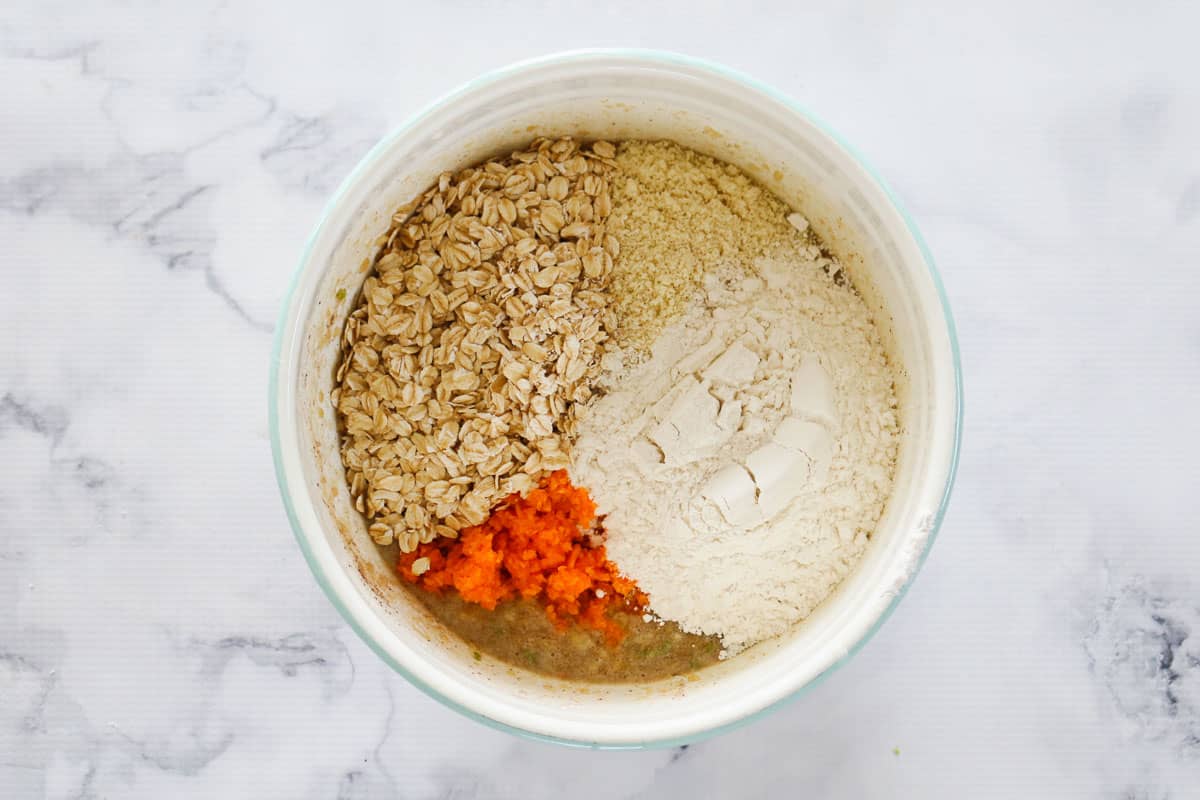 Oats, grated carrot, almond meal and flour added to the wet mixture.