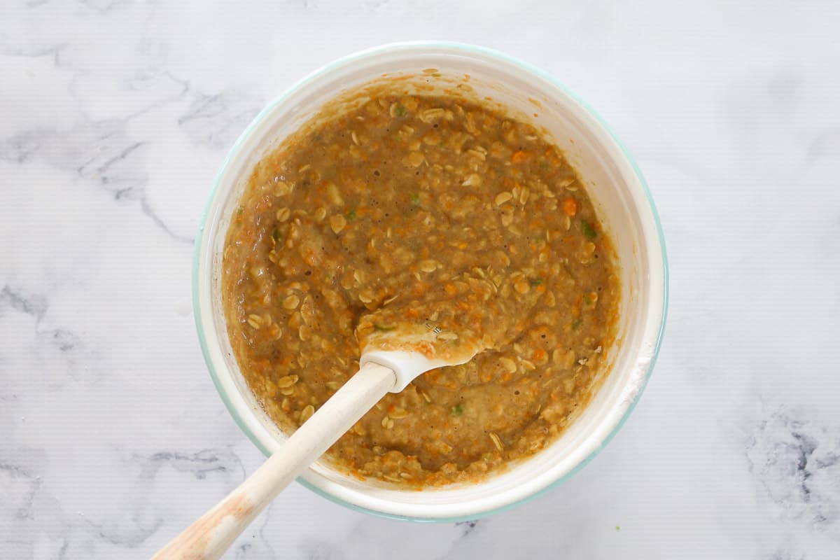 All ingredients gently mixed in a bowl with a wooden spoon.