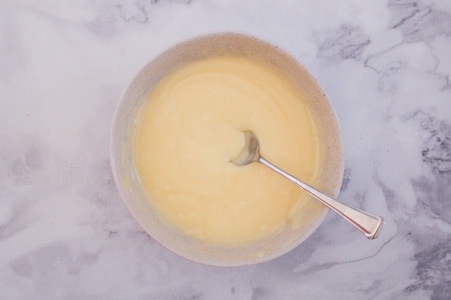 A mixing bowl with a creamy mixture. 