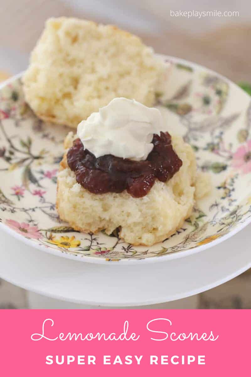 A light and fluffy scone topped with whipped cream and jam.