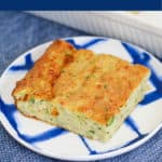 A piece of homemade zucchini slice on a blue and white plate.