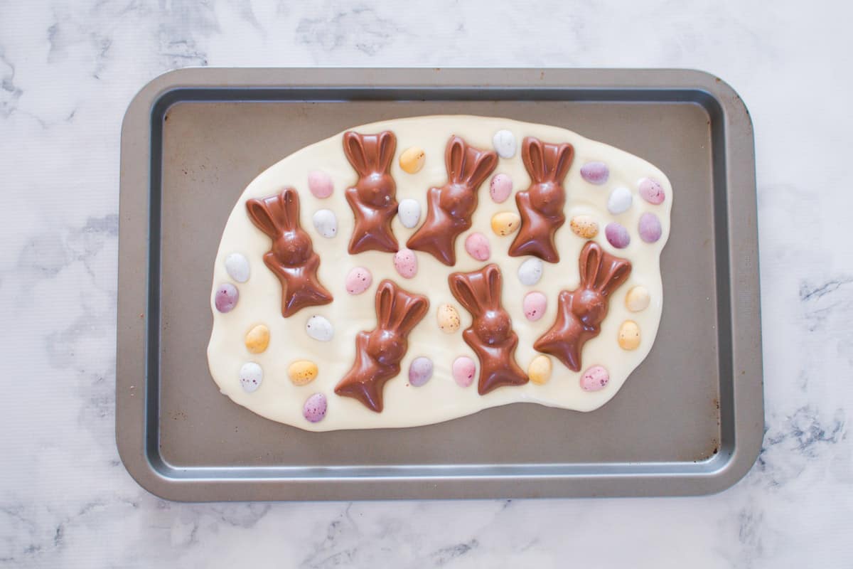 Malteser easter bunnies, pastel eggs on melted white chocolate.