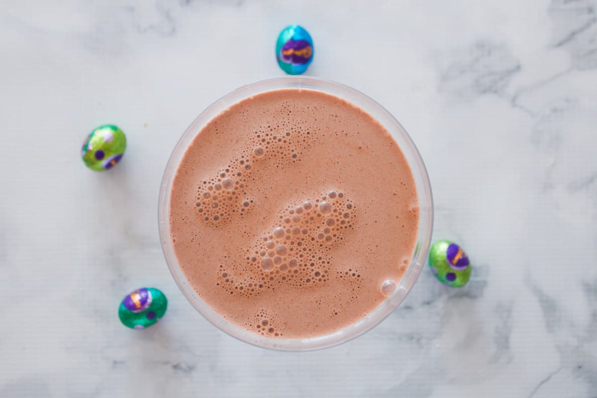 A chocolate cocktail surrounded by mini easter eggs.