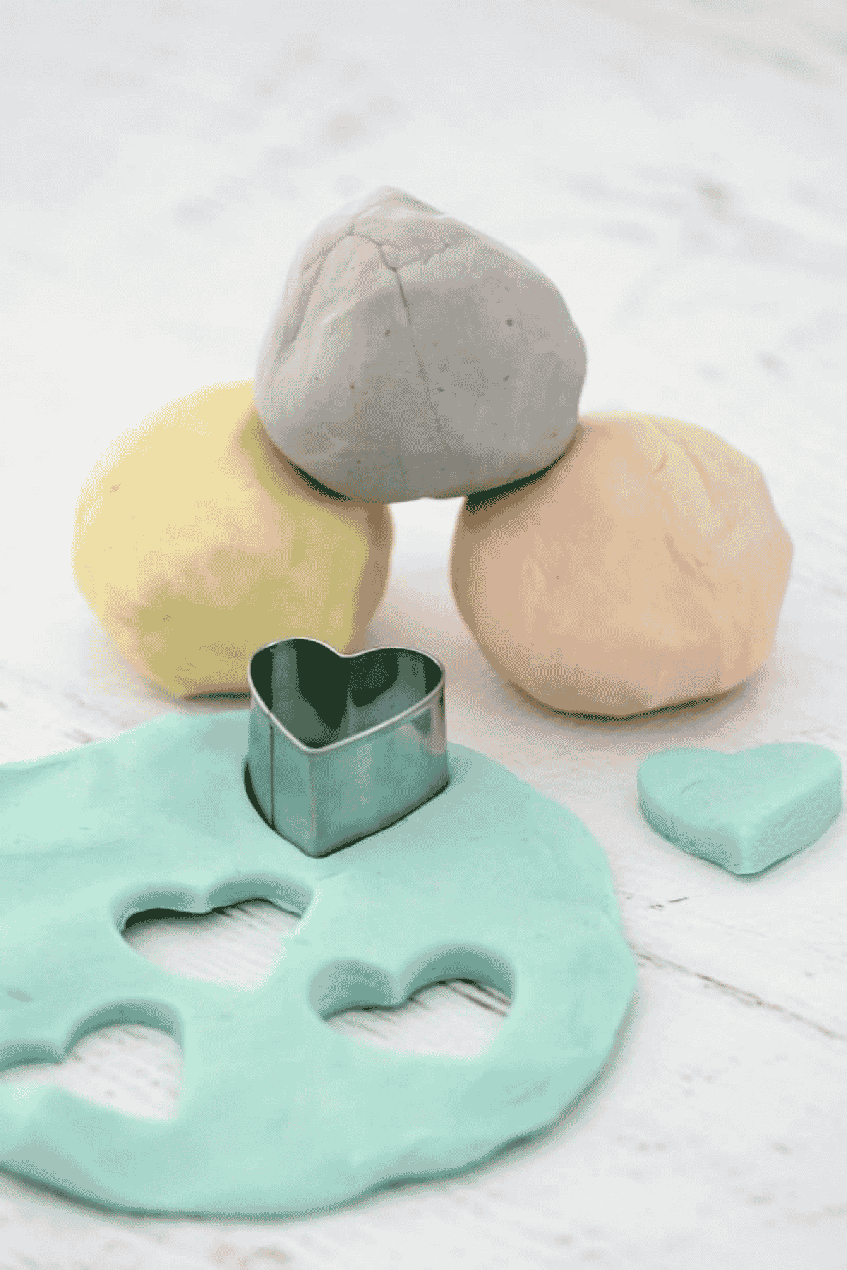 Colourful playdough balls on a bench.