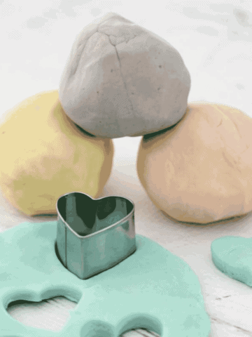 Balls of homemade playdough on a bench.