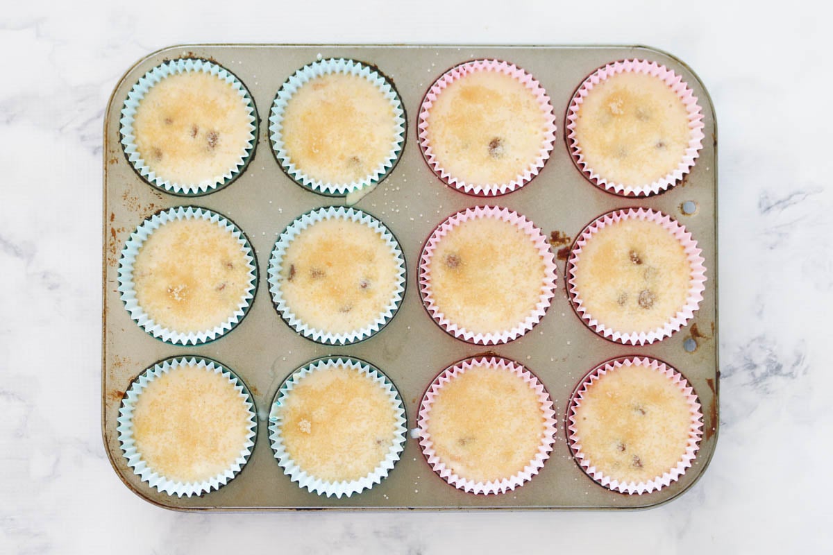 Muffin mixture with choc chips in a baking tray.