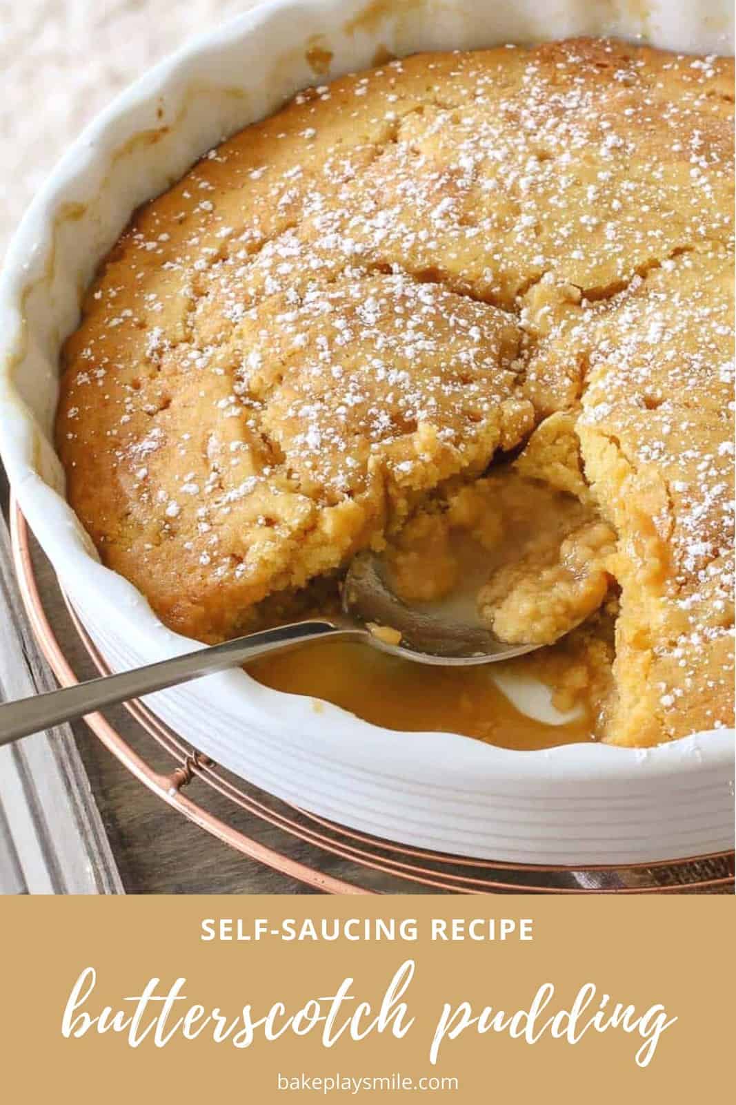 A butterscotch self saucing pudding in a baking dish with a spoon scooping a portion out.
