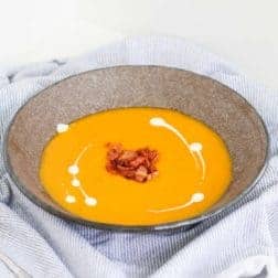 A rich and creamy classic roast pumpkin soup recipe that's so simple to make... try it served with crispy bacon, a swirl of cream and lots of crusty buttered bread for the ultimate comfort food meal. 
