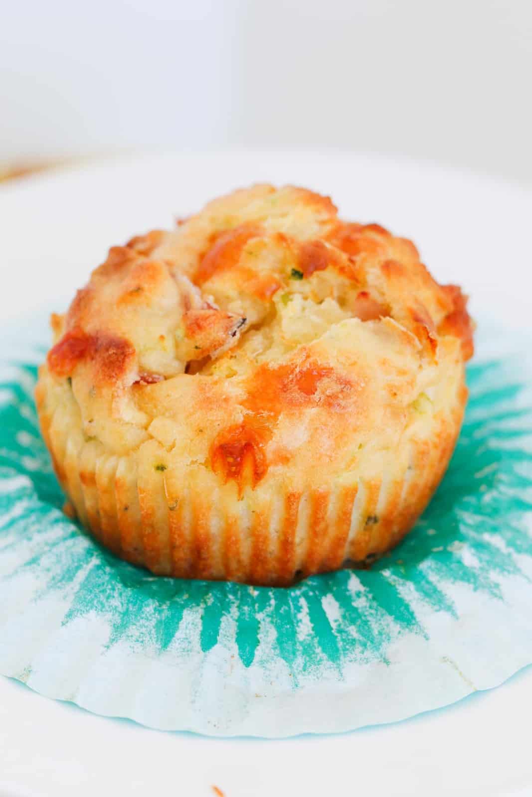 A savoury muffin being opened from a muffin case.
