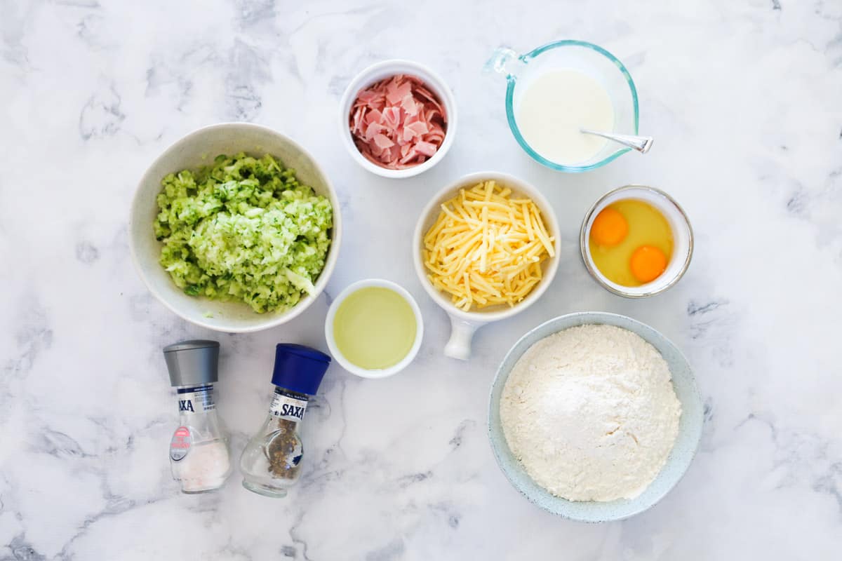 The ingredients for savoury muffins made with zucchini, ham and cheese.
