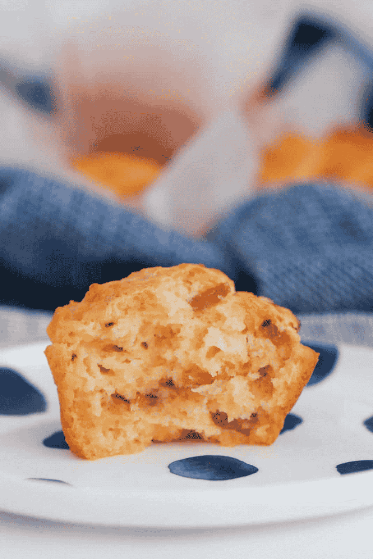 A bacon and cheese savoury muffin on a plate.