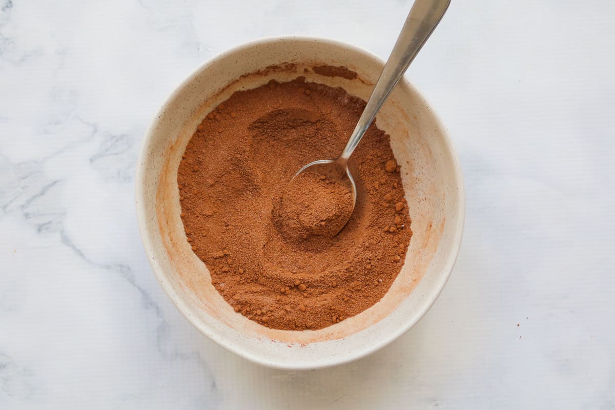 Caster sugar and cocoa powder mixed together in a bowl.