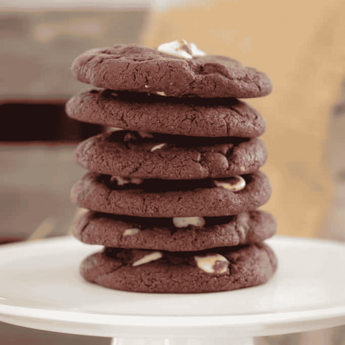 A stack of chocolate cookies with white chocolate chips.
