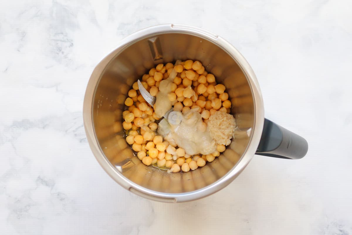 Chickpeas, tahini, minced garlic, lemon juice in a Thermomix bowl.