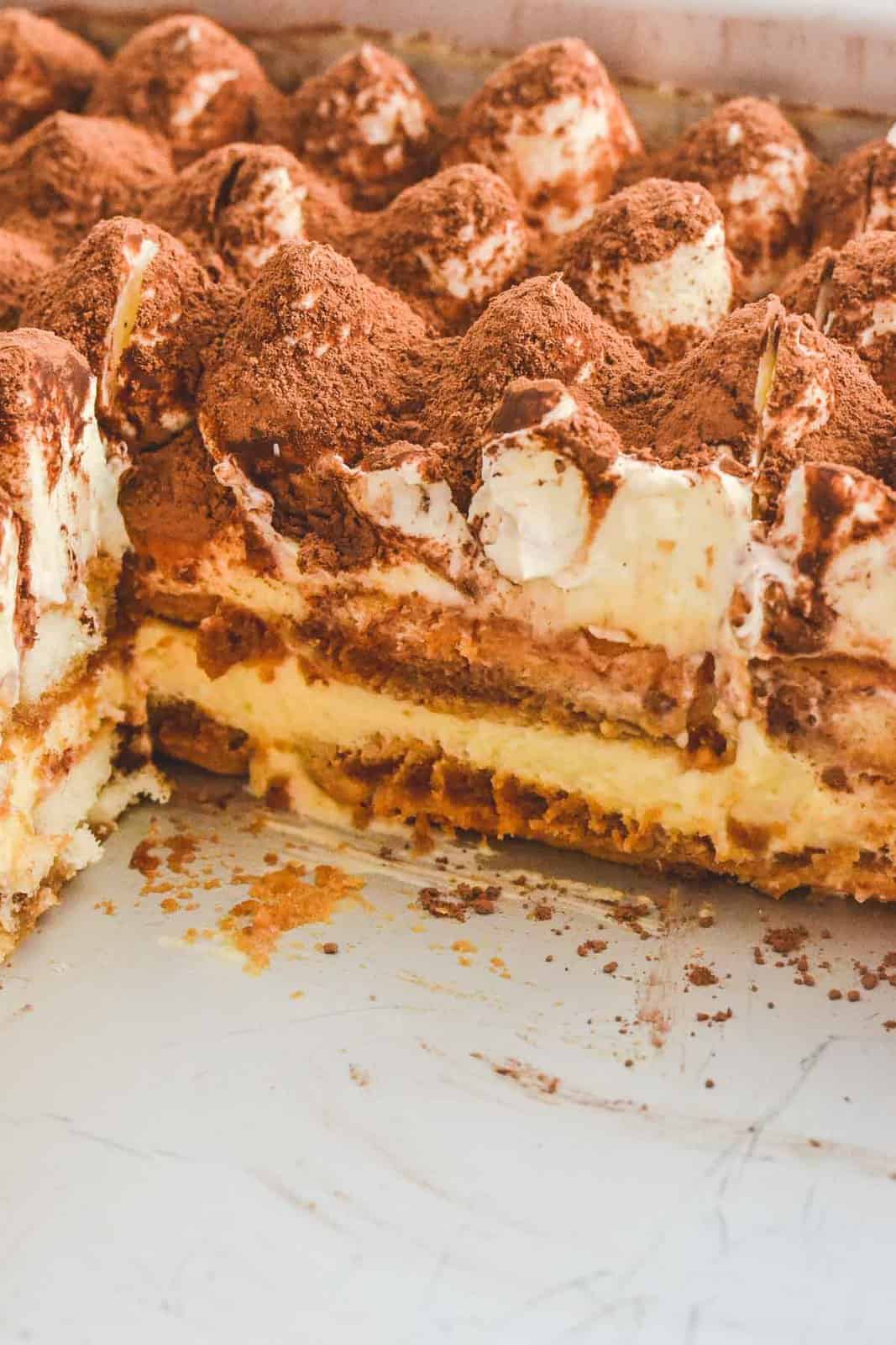 A creamy dessert with layers of biscuits, mascarpone, coffee, whipped cream and cocoa.