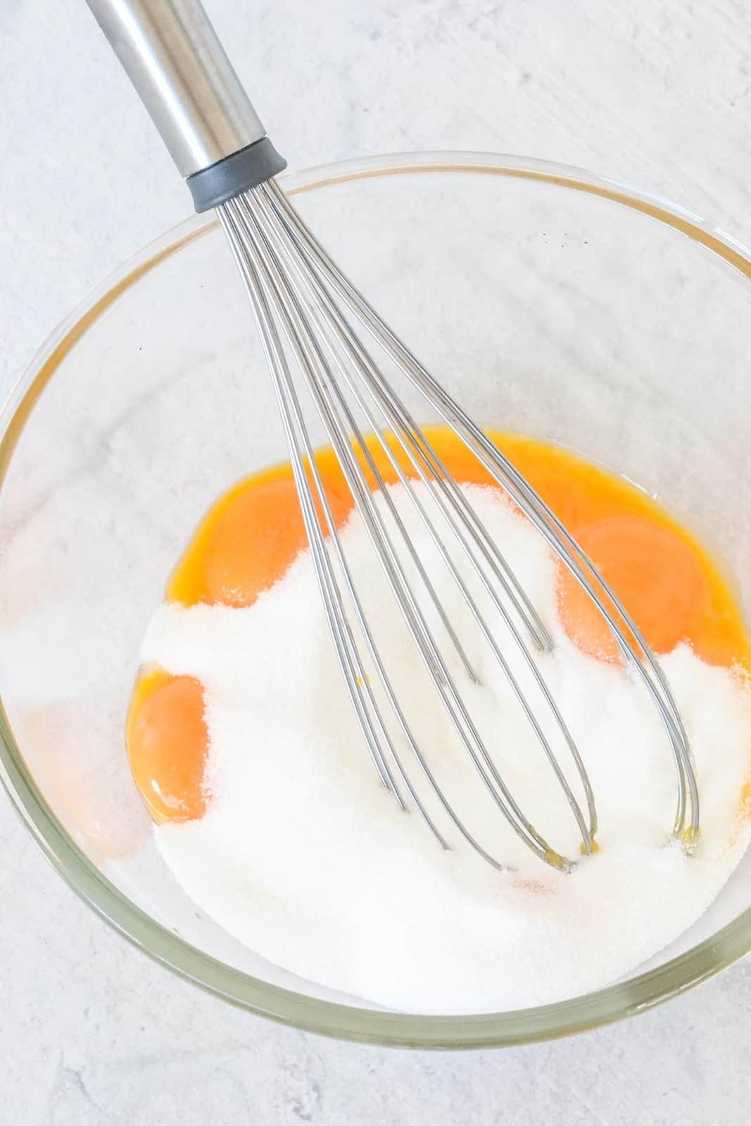 Egg yolks and sugar in a bowl