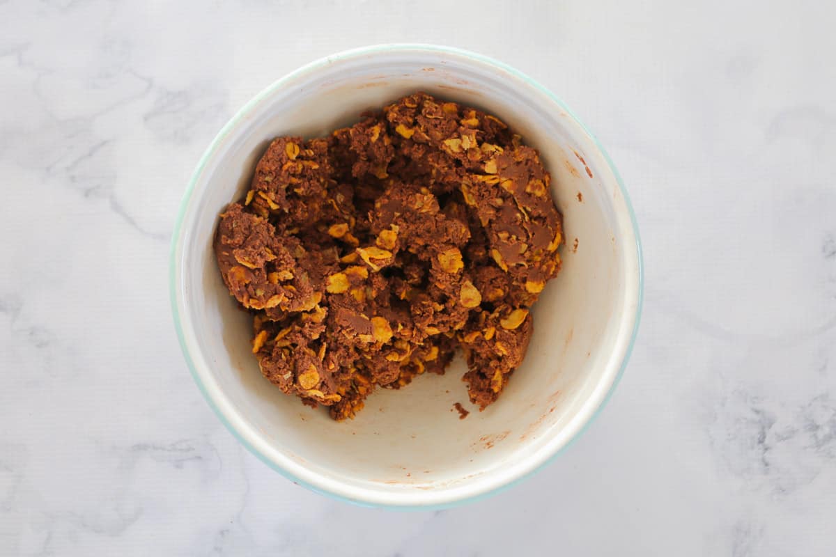 Chocolate biscuit mixture with cornflakes in a bowl.
