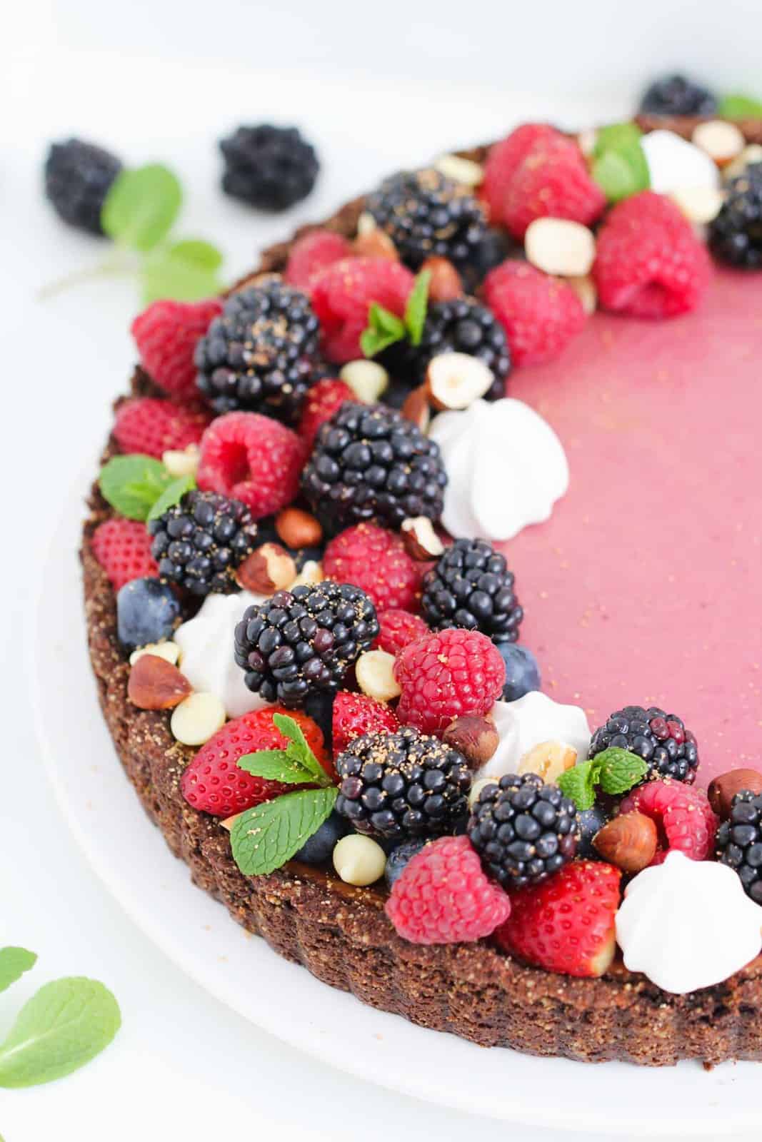 A Blackberry Cheesecake Tart decorated with blackberries and raspberries