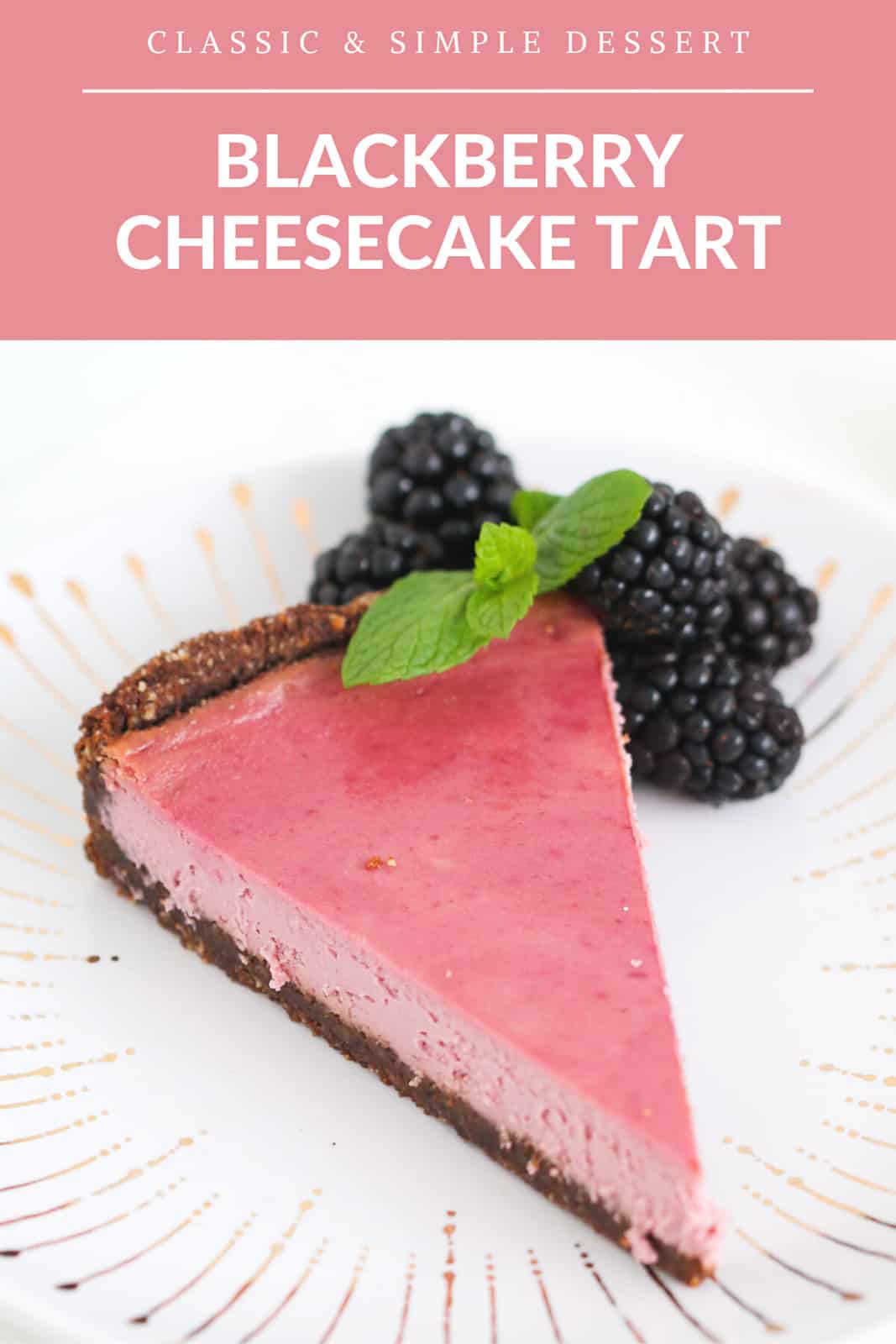 A slice of blackberry cheesecake tart on a white and gold plate with fresh blackberries and mint leaves.