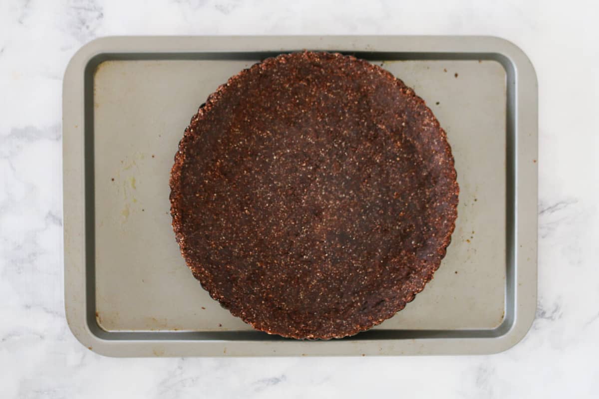 Chocolate crumbs pressed into a loose bottom tart tin.
