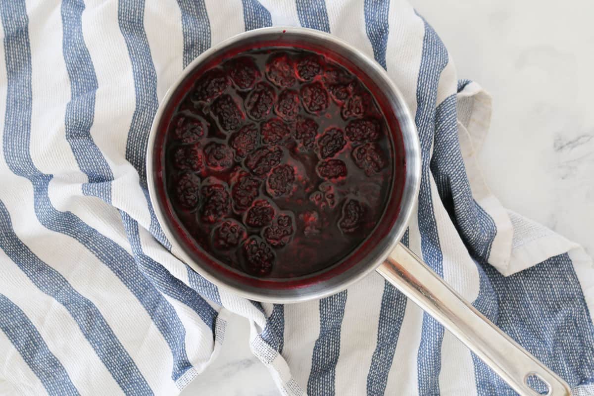 Blackberries in a saucepan that have been simmered until softened.