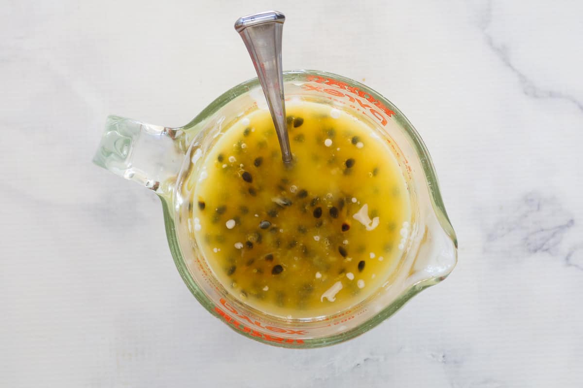 Passionfruit syrup mixture in a pyrex measuring jug.