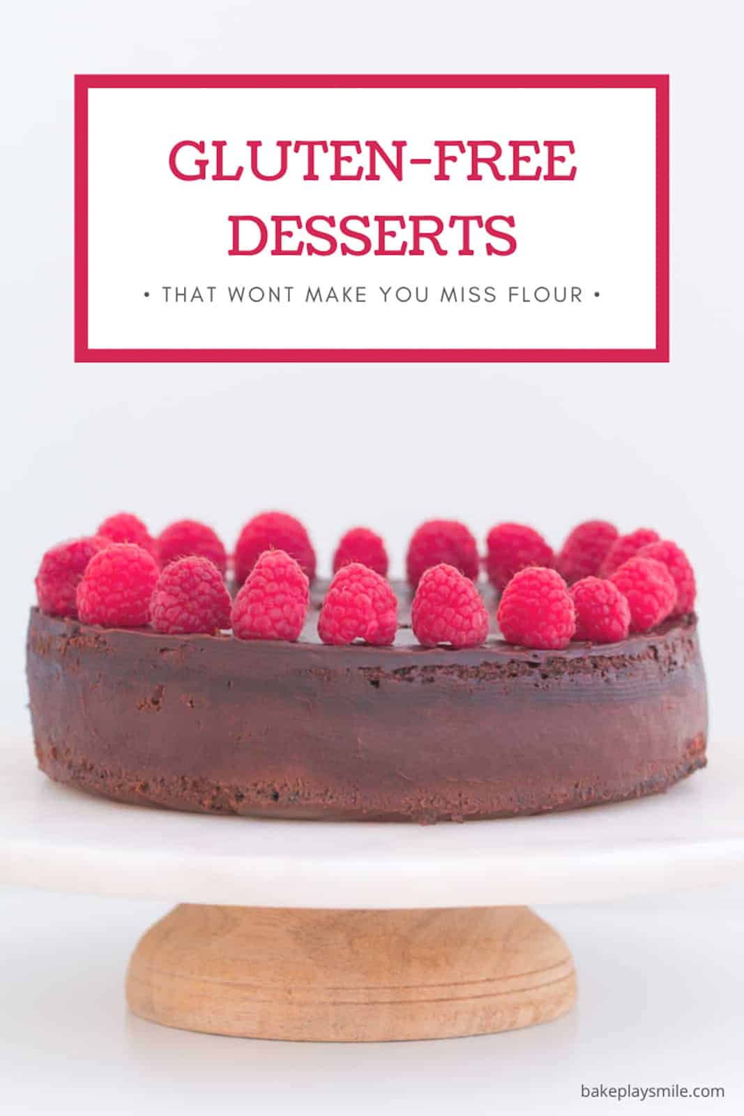 A chocolate cake on a plate with raspberries on top.