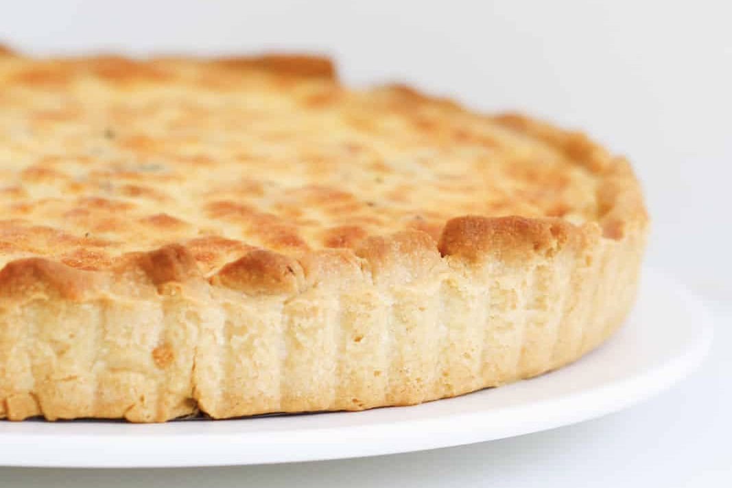 A baked egg and bacon quiche in homemade pastry shell.